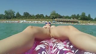 Crazy girlfriend masturbates while nude on a inflatable matress in the sea
